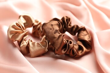Hair scrunchies on pink silk fabric, closeup