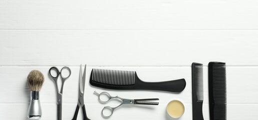 Many different barber's tools on white wooden table, flat lay. Space for text