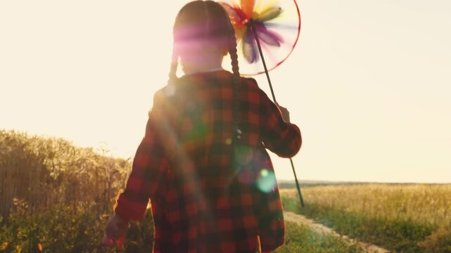 Little girl Child Kid running into sunset with pinwheel hand, toy windmill hand little girl running into the sunset, children dream, wind, Happy childhood Running Child Kid Baby, Happy family