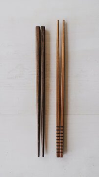 Two wooden chopsticks isolated on a white background