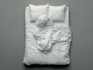 Cozy unmade bed with white linens and pillows.