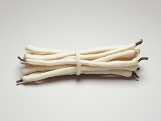 Fresh vanilla beans tightly bundled together.
