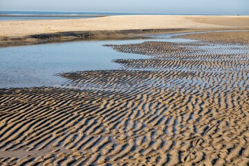 Low tide exposing sand ripples on a beach at daytime