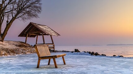 Frozen lake sunset view with wooden bench and gazebo