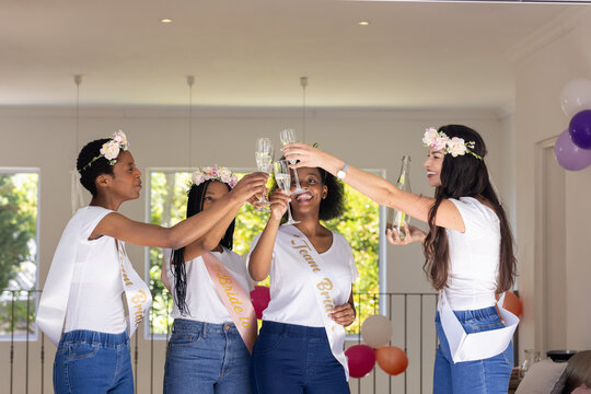 Bachelorette party, toasting with champagne, diverse friends celebrating at bridal shower party