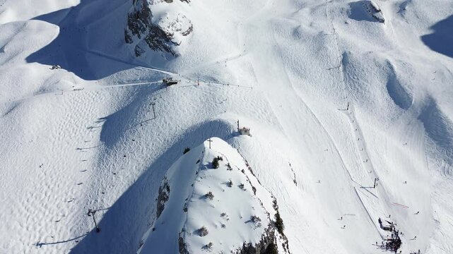 Panoramic travel shot revealing an active and snow-covered ski area