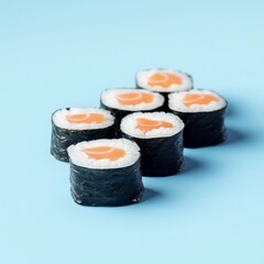 Fresh salmon maki sushi rolls on pastel blue background for Japanese food menu, restaurant ads, or minimalist culinary blogs