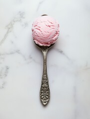 Pink strawberry ice cream scoop on vintage ornate spoon over marble background, ideal for dessert branding, minimalist food styling, or summer menu design