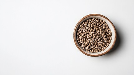 Bowl of textured seeds on white background flat lay food photography