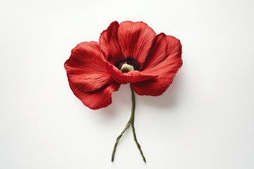 A meticulously crafted red poppy flower, detailed petals and stem, artfully presented against a stark white background.