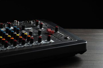 Professional mixing console on wooden table, closeup