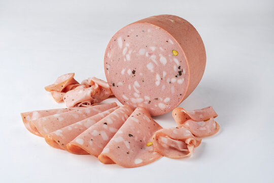 Traditional Italian artisan handcrafted fine mortadella with pistachio and truffle offered as close-up on white background with copy space &ndash; isolated