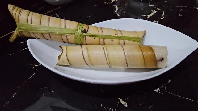 Lepet or Leupeut or Lepat is a type a sticky rice or ketan mixed with peanut cooked with coconut milk,packed inside young coconut leaf or janur or palm leaf