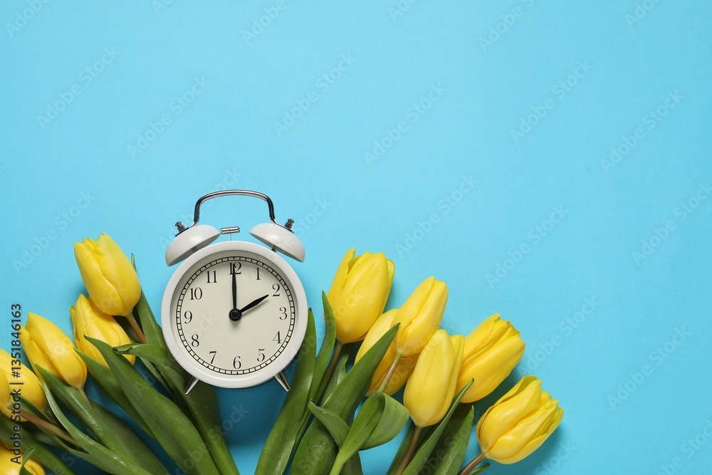 Poster spring time. alarm clock and beautiful tulips on light blue background, flat lay. space for text