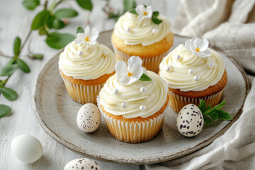 Easter cupcakes with white frosting and decorative flowers.  