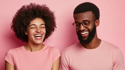Fototapeta premium Joyful couple laughing together against a pink background showcasing happiness and connection in a vibrant atmosphere