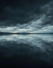 Fototapeta premium Dark, still water reflecting an ominous sky, subtle ripples, background, surface