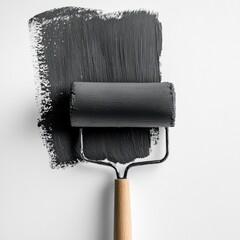 Obraz premium Dark paint roller on white background. A dark gray paint roller applies paint to a white surface, showcasing the application process.