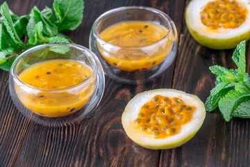 Passion Fruit Pulp in Glass Bowls on Rustic Wood