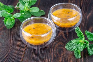 Passion Fruit Pulp in Glass Bowls on Rustic Wood