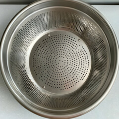 Stainless steel steamer basket, kitchen utensil, cooking, food preparation, close-up view