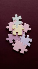 Fototapeta premium Puzzle pieces in a mix of soft colors like pastel pink, lavender, and pale yellow, fitting together on a rich, dark maroon background