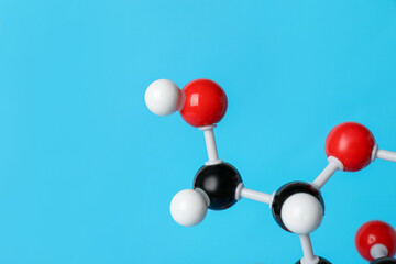Molecule of glucose on light blue background, closeup and space for text. Chemical model