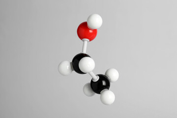 Molecule of ethanol on light grey background. Chemical model