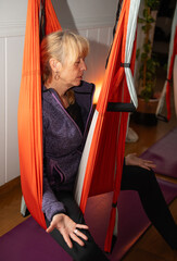 woman taking aerial yoga classes