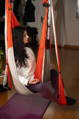 woman taking aerial yoga classes