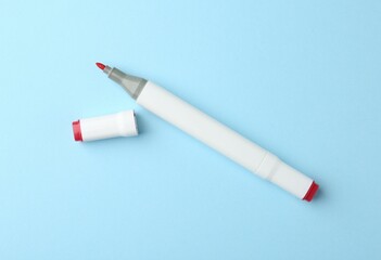 One color double sided marker on light blue background, top view