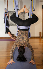 woman stretching doing aerial yoga