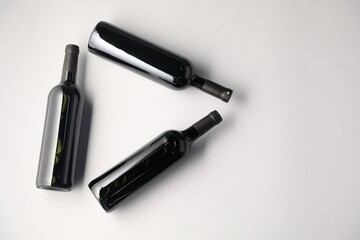 Bottles of wine on white background, flat lay. Space for text
