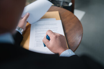 Businessman stamping an official document. Concept of approval, certification, contract signing,...