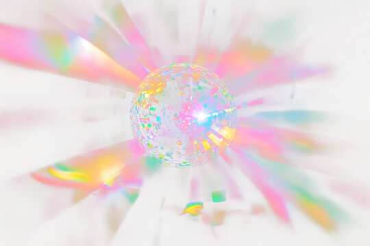 Colorful disco ball with radiating light streaks.