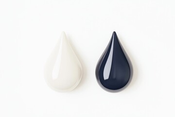 Two contrasting ink drops, one white and one black, positioned side-by-side on a white background.  The drops are glossy, and have a teardrop shape