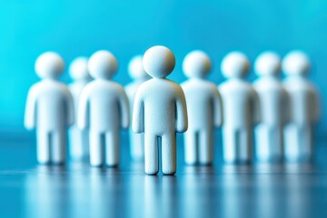 Minimalist Group of White Figurines on Blue Background with Focus on One Human Shape Representing Individuality and Leadership in a Corporate Environment