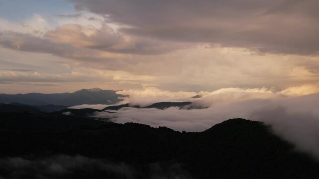 Mountains at morning light panorama with heavy clouds lying low over the ridges silhouettes