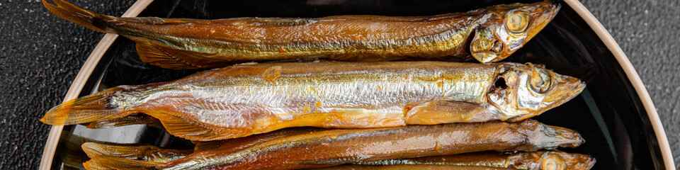 smoked capelin fish sprat vegetables dish fresh delicious gourmet food background on table rustic...