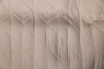 part of the fabric from which the mattress is sewn after prolonged use