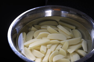 hand cut chips in bowl with water