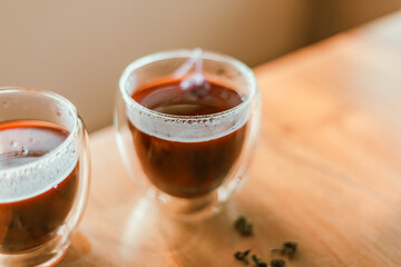 Red tea or called “ Dragon blood tea ” in the small clear glass