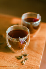 Red tea or called “ Dragon blood tea ” in the small clear glass