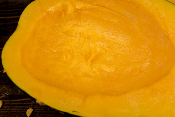 freshly cut orange pumpkin with cooking seeds