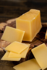 a piece of sliced hard mature cheese in close-up