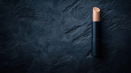 This image features a sleek stick foundation on a textured dark surface, ideal for beauty blogs, makeup tutorials, or cosmetic product promotions, emphasizing elegance and simplicity,