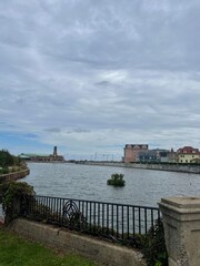 view of river reservoir with buoy in industrial neighborhood  