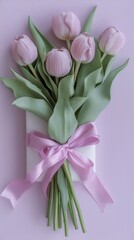 Fototapeta premium Pink Tulips Arranged Beautifully in a White Gift Box With a Pink Ribbon on a Soft Purple Background