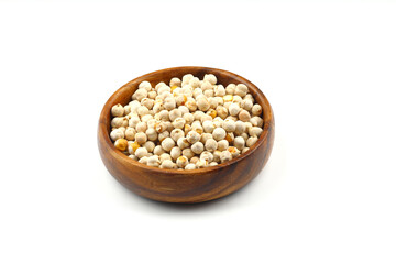 Roasted white chickpeas in wooden bowl on white background, top view. White chickpeas, with their high fiber content, are very healthy to consume.