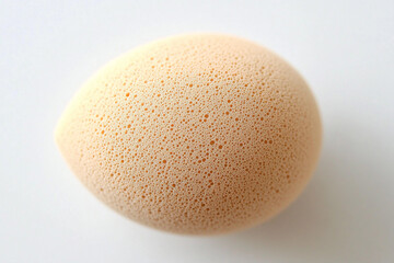 Applying foundation in a beauty routine using a makeup sponge for a flawless finish